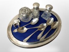 A silver framed oval photograph frame together with five tea spoons,