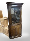 An oak astral glazed corner cabinet,