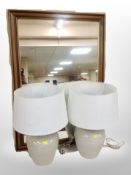 A contemporary overmantel mirror and a pair of crackle glazed table lamps