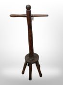 An antique five-legged washing dolly