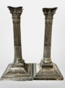 A pair of Walker & Hall silver-plated Corinthian column candlesticks,