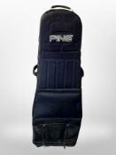 A Ping golf bag on castors