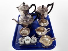 A four piece tea service together with three piece service and further stainless steel cruet