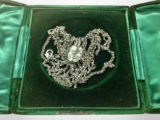 A Thierry Mugler face pendant on chain,