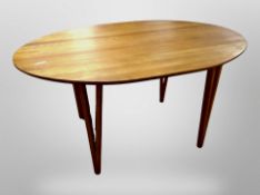 A late 20th century Danish oval dining table and set of four oak ladder backed chairs