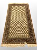 A machine made rug of Persian design,