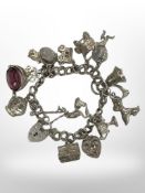 A silver charm bracelet 69.4g.