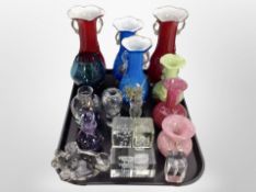 Two pairs of coloured glass twin handled vases, clear glass paperweights,