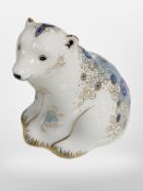 A Royal Crown Derby Polar Bear Cub Sitting paperweight with gold stopper