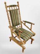 A Danish oak bobbin turned rocking armchair