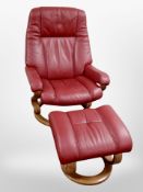 A red stitched leather relaxer armchair with matching footstool