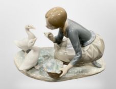 A Lladro figure of a girl feeding ducks,