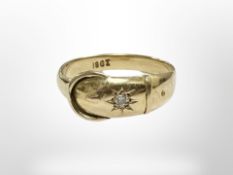 An 18ct yellow gold buckle ring set with a diamond, size N. CONDITION REPORT: 2.8g.