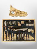 A framed montage depicting musical instruments of the Andes together with an set of pipes