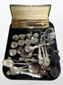 A group of silver plate and stainless steel flatwares, tea strainer,