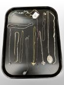 A group of necklaces, white metal pendant locket on chain,