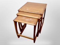 A teak nest of three tables,