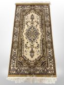 A machine made rug of Persian design,