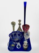 A two-tone blue and clear glass fruit bowl, slender vase, large pink crystal wine glass,