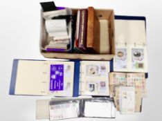 A box of several albums of first day covers,