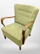 A carved and stained beech armchair