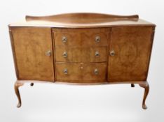 A figured walnut serpentine fronted sideboard,