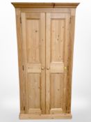 A contemporary pine double door wardrobe,