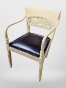 A painted Regency style armchair with studded brown leather seat