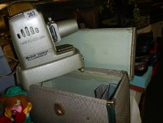 A cased Aldis slide projector.
