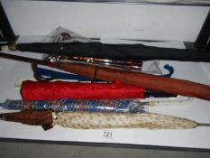 A vintage parasol/umbrella, a folding walking stick and shoe horns.