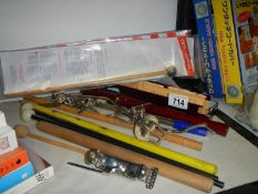 A vintage recorder and a penny whistle and drumsticks.
