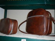 A brown leather shoulder bag and one other.
