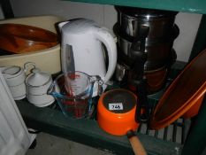 A Le Crueset milk pan and other kitchen items.