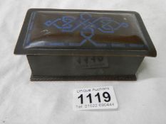 A small bronze box with blue inlay.