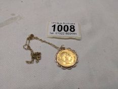 A 1907 Edward VII gold half sovereign in a 9ct gold mount on a 9ct gold chain, total weight 5.8 g