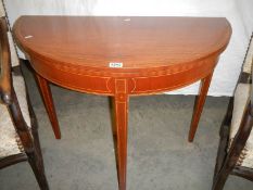 An early 20th century fold over mahogany card table,. COLLECT ONLY.
