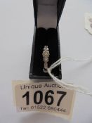 A circa 1940's diamond three stone ring set in platinum, tests as 18ct, size K.