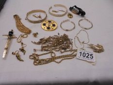 A mixed lot of yellow metal jewellery including bangles, earrings, chains etc.,