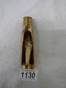 A item of trench art being a gun shell with figure of the Virgin Mary inside.