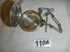 A silver pocket watch case on plated chain.