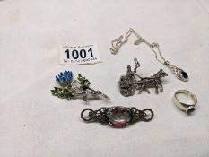 A silver pendant, silver ring and three marcasite brooches.