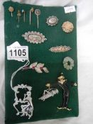 A good lot of brooches and stick pins including some silver.