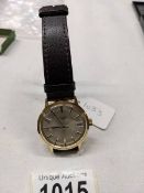 A Rotary manual wind wrist watch with gold coloured case, stainless steel back, champagne dial