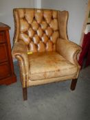 A leather deep buttoned wing arm chair, COLLECT ONLY.