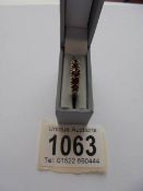 A garnet ring with five graduated stones, dated London 1981, size P.