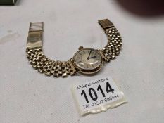 A 9ct gold Omega wrist watch on a 9ct gold bracelet, in working order, total weight 49.4 grams.