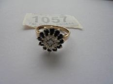 A diamond and sapphire ring in 9ct gold hall marked Birmingham 1976 size M half.