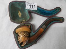 An old cased Meerscham pipe of a man's head.