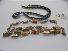 A vintage abalone shell necklace and a hematite necklace with turquoise coloured stone insets.
