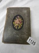 An antique postcard album containing many historical photographs and postcards.